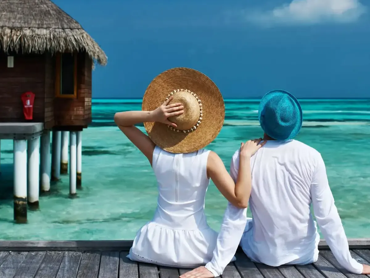 Couple walking along Zanzibar beach during a 12 day honeymoon